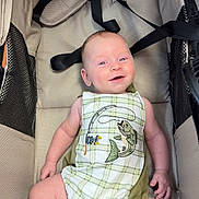 Krue Burgess is registered to the contest to win money with this photo: arms, baby, child, comfortable, cute, embroidery, fabric, fish, fishing_rod, happy, head, indoors, infant, legs, plaid_clothing, portrait, seatbelt, skin, smiling, stroller