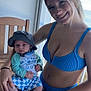 Krue Burgess is registered to the contest to win money with this photo: baby, beach, bikini, bracelet, child, clothing, happy, hat, ocean, outdoor, person, portrait, ring, sitting, smile, summer, sunlight, table, woman, wood
