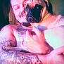 Winstin Harvala joined the competition — help win amazing prizes! man, dog, pug, tattoo, arm, face, pet, holding, smile, indoor, portrait, closeup, skin, animal, friendship, love, cute, furry, companionship, warm_light
