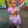 child, girl, princess, dress, purple, tiara, wand, arcade, indoor, carpet, person, colorful, toy, play, floor, lighting, costume, young, portrait, fun