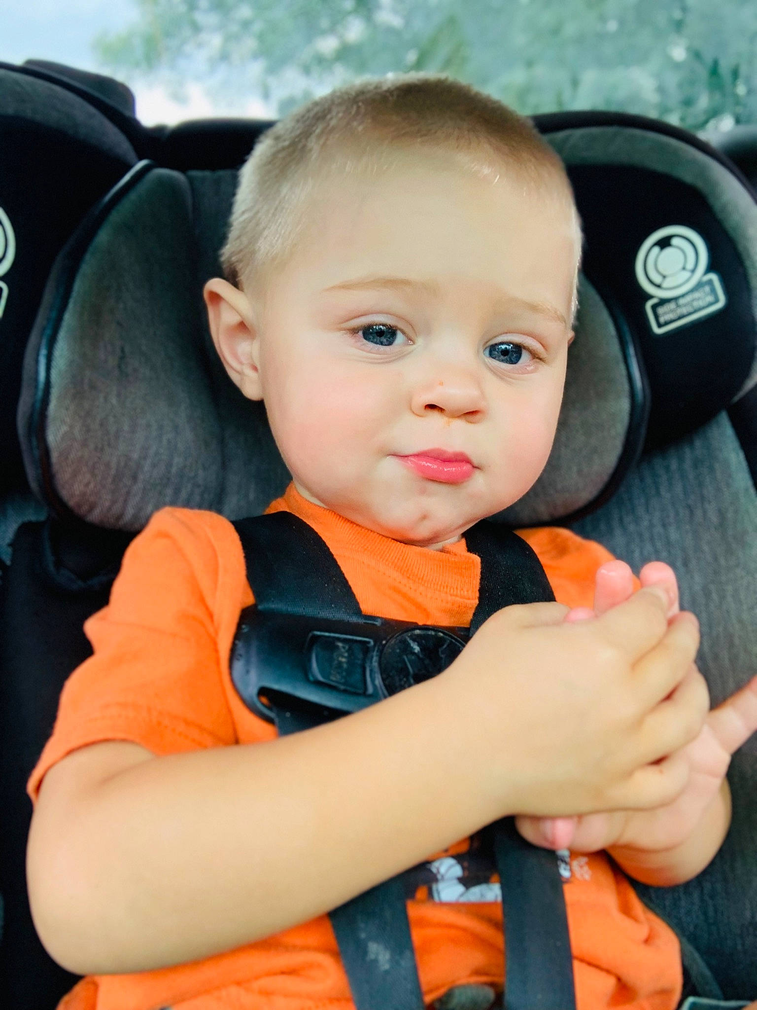 Nathan is registered to the contest to win money with this photo: auto_part, baby, baby_carriage, baby_in_car_seat, baby_products, baby_toddler_clothing, car_seat, child, comfort, electric_blue, facial_expression, fun, happy, orange, person, personal_protective_equipment, seat_belt, sitting, skin, smile