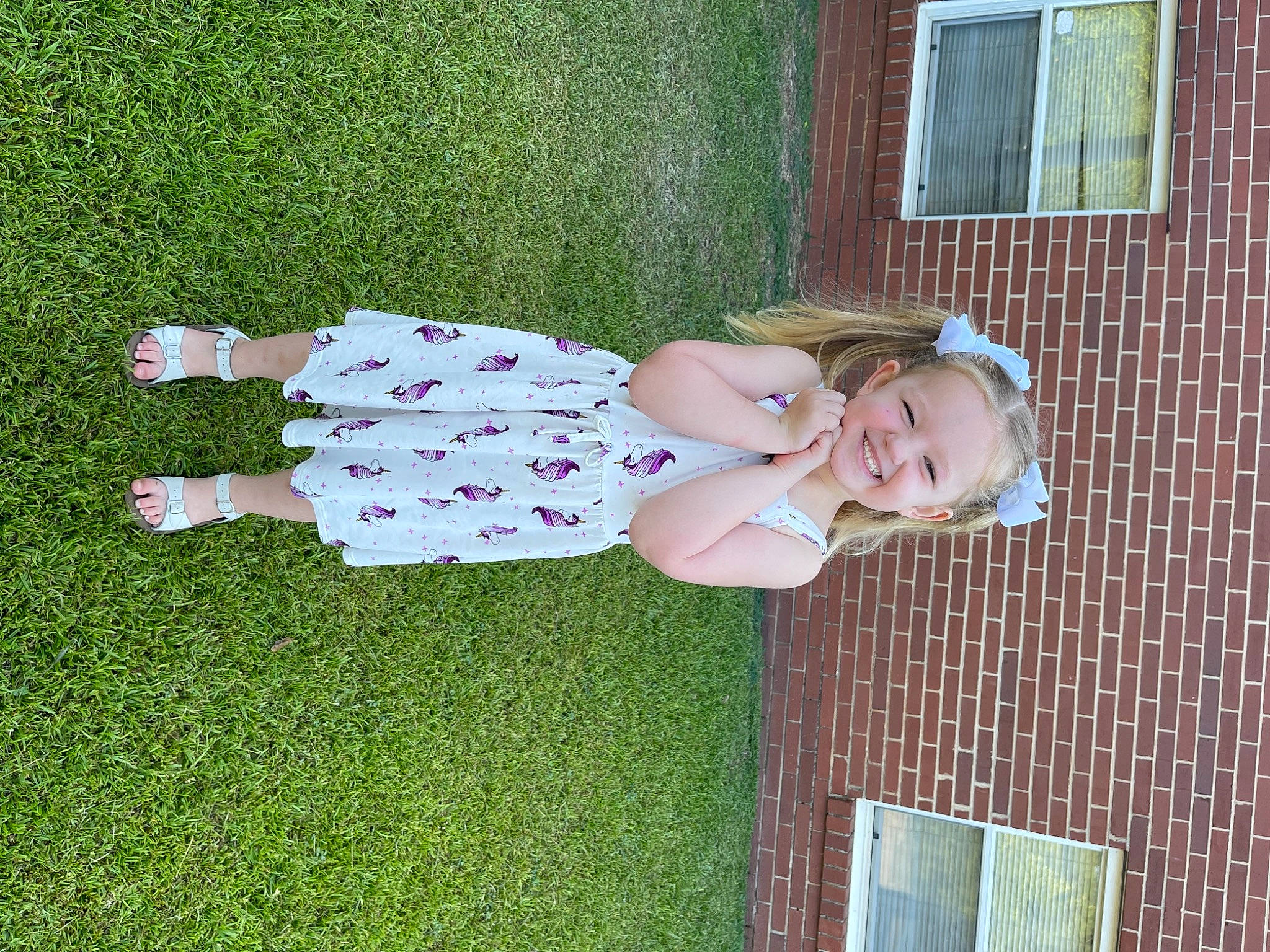 Ava joined the competition — help win amazing prizes! baby, baby_toddler_clothing, child, dress, fun, grass, green, happy, joy, lawn, leisure, mammal, pattern, people_in_nature, person, pink, plant, sitting, smile, toddler