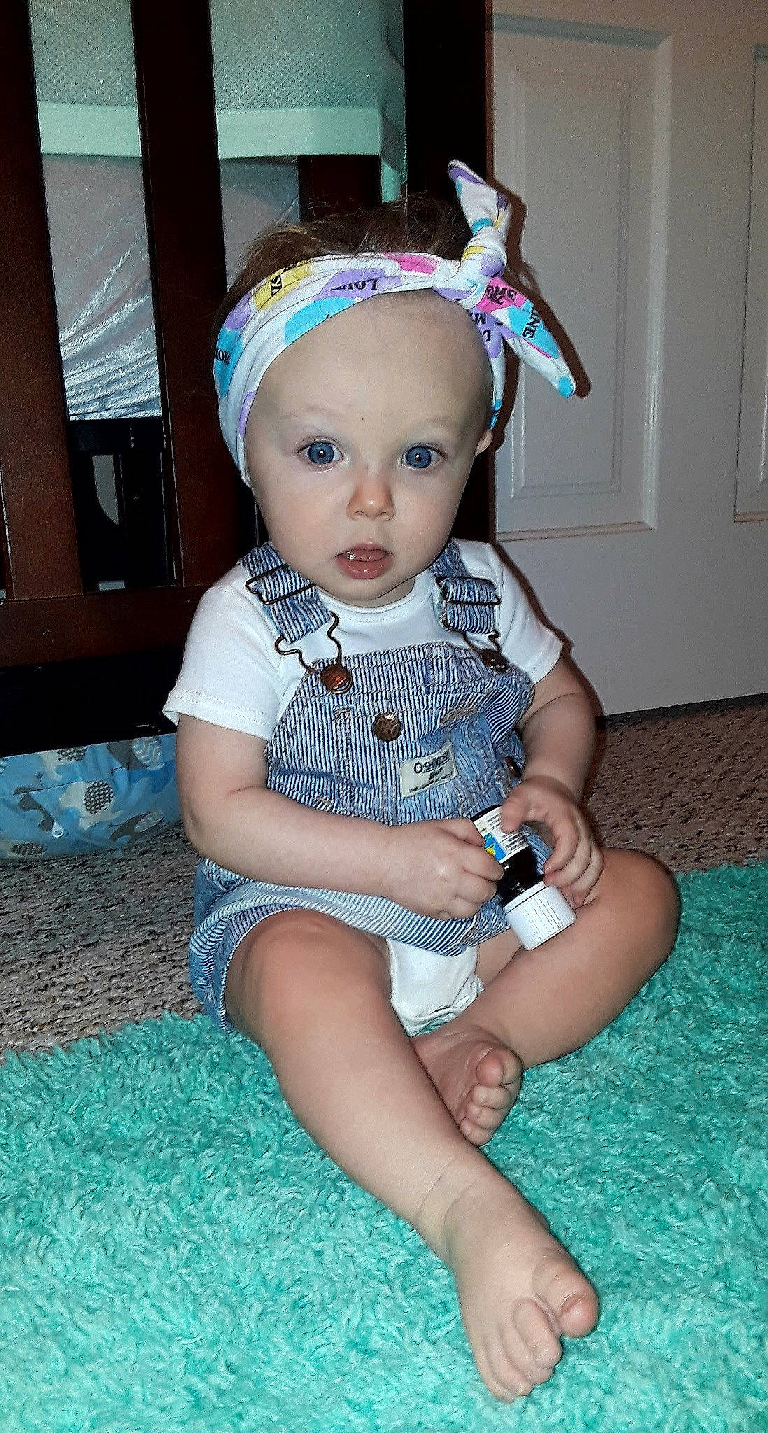 Analiyah is registered to the contest to win money with this photo: abdomen, baby_products, child, eye, fun, girl, hair_accessory, headband, headgear, human_hair_color, infant, iris, leg, person, product, sitting, skin, surprise, textile, toddler