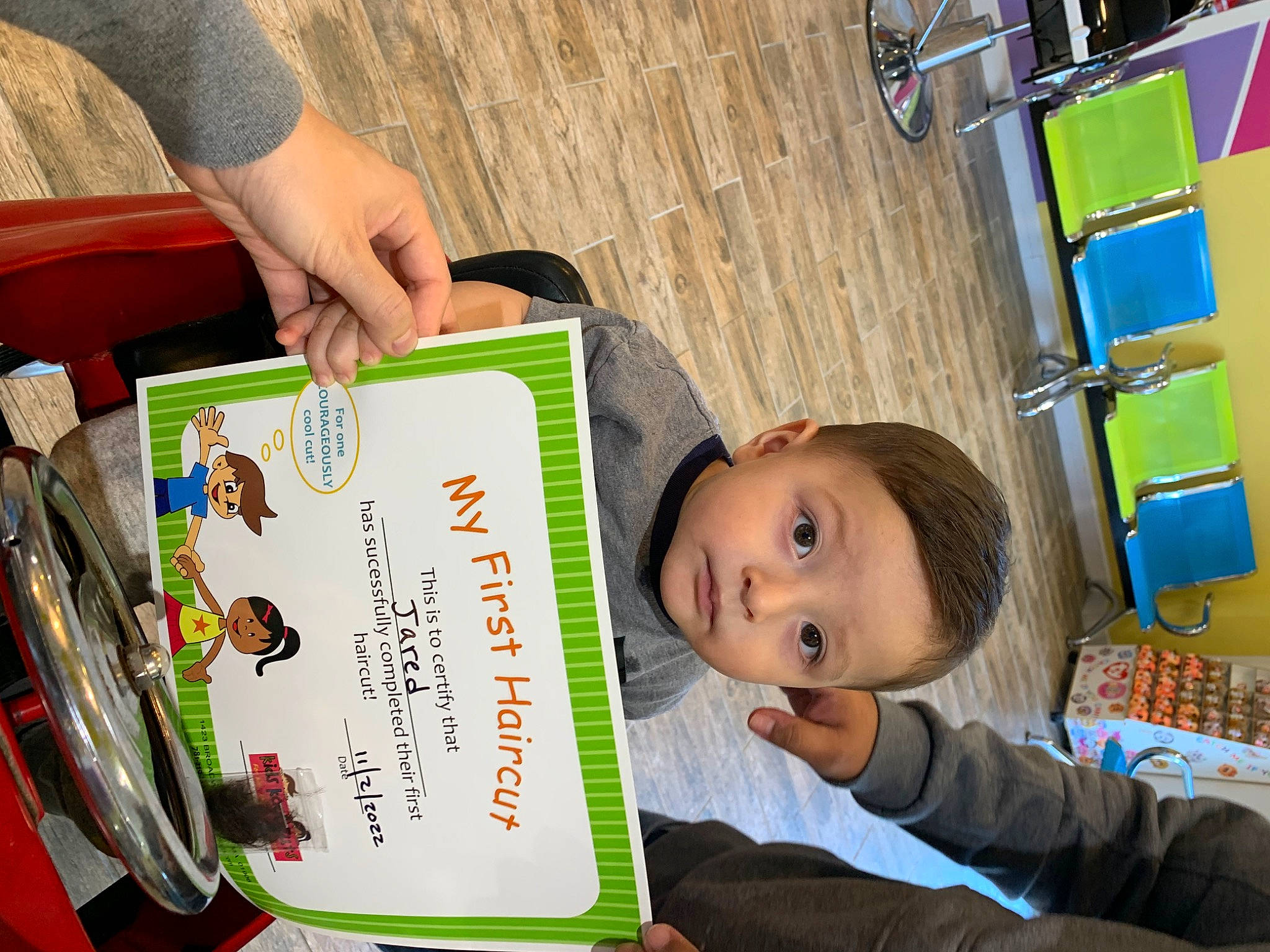 Jared is registered to the contest to win money with this photo: baby, child, event, font, fun, learning, leisure, people, person, photograph, photography, play, publication, recreation, room, sitting, t_shirt, toddler, tree