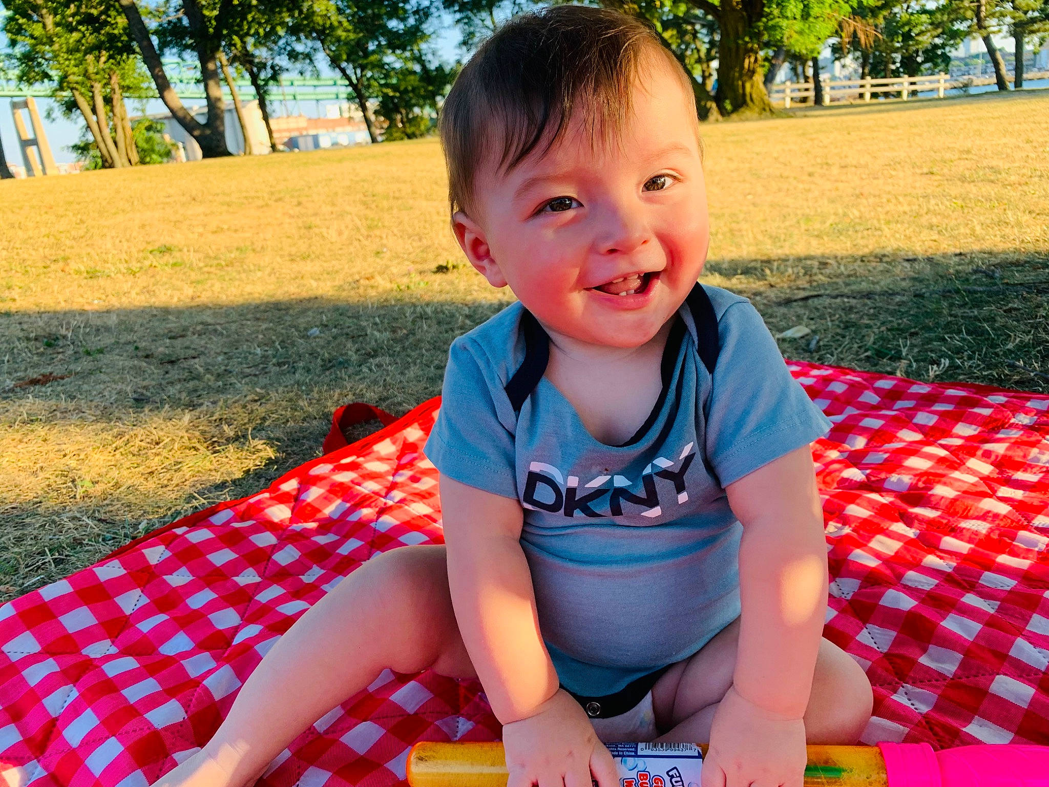 Jared joined the competition — help win amazing prizes! baby, baby_toddler_clothing, facial_expression, fun, grass, happy, leg, leisure, pattern, people_in_nature, person, plaid, plant, public_space, recreation, skin, smile, sunlight, thigh, toddler