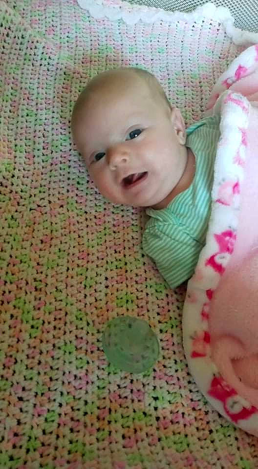 Octavia is registered to the contest to win money with this photo: baby, baby_toddler_clothing, cheek, child, comfort, eyelash, facial_expression, happy, head, iris, linens, lip, mouth, nose, pattern, person, product, skin, smile, textile