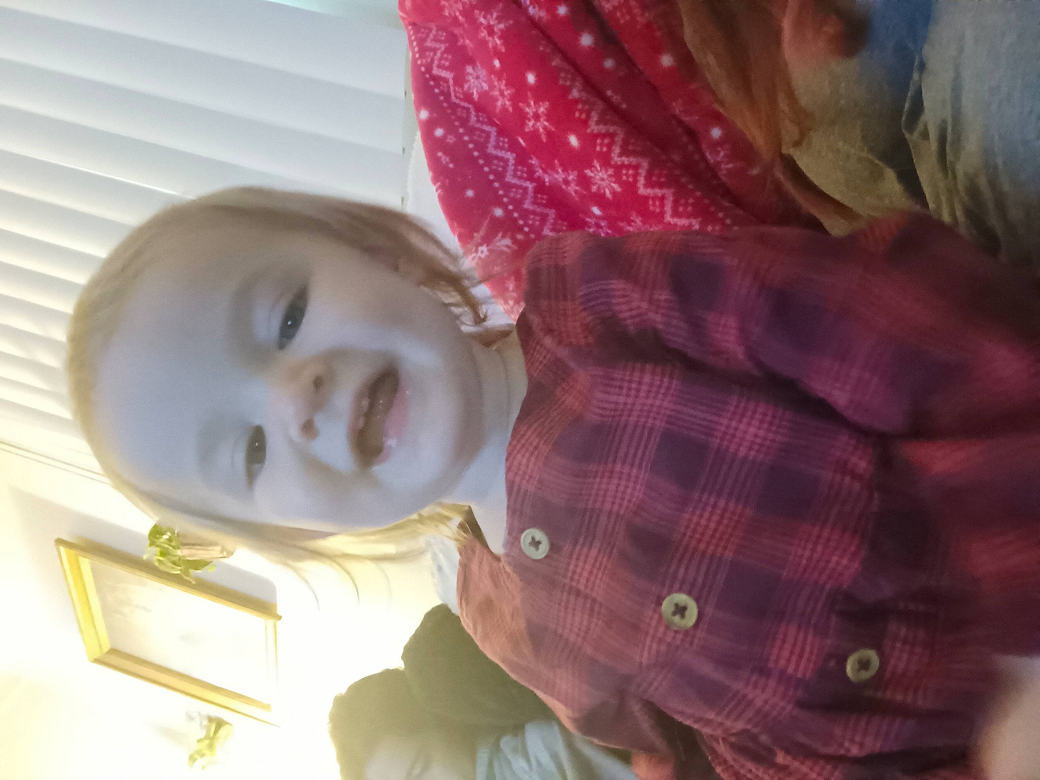 Octavia is registered to the contest to win money with this photo: baby, baby_toddler_clothing, cheek, child, comfort, happy, human_body, iris, linens, magenta, nose, pattern, person, plaid, room, skin, sleeve, smile, tartan, toddler