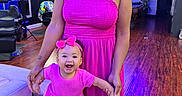 Sevyn is registered to the contest to win money with this photo: baby, bow, child, couch, family, hair_salon, happy, holding_hands, indoor, mother, neon_lighting, photography, pink_dress, portrait, salon, sandals, smiling, standing, woman, wooden_floor