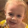 Alivia is registered to the contest to win money with this photo: toddler, child, smile, face, hair, pony_tail, sunflower, yellow, shirt, clothing, couch, texture, indoor, happy, closeup, portrait, baby, person, cute, young_child