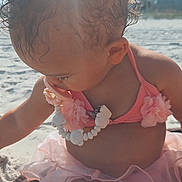 Skye joined the competition — help win amazing prizes! toddler, child, beach, sand, sunlight, curly_hair, pink_swimsuit, flower, necklace, summer, outdoor, playing, sunny, vacation, cute, young_child, sitting, barefoot, nature, daytime