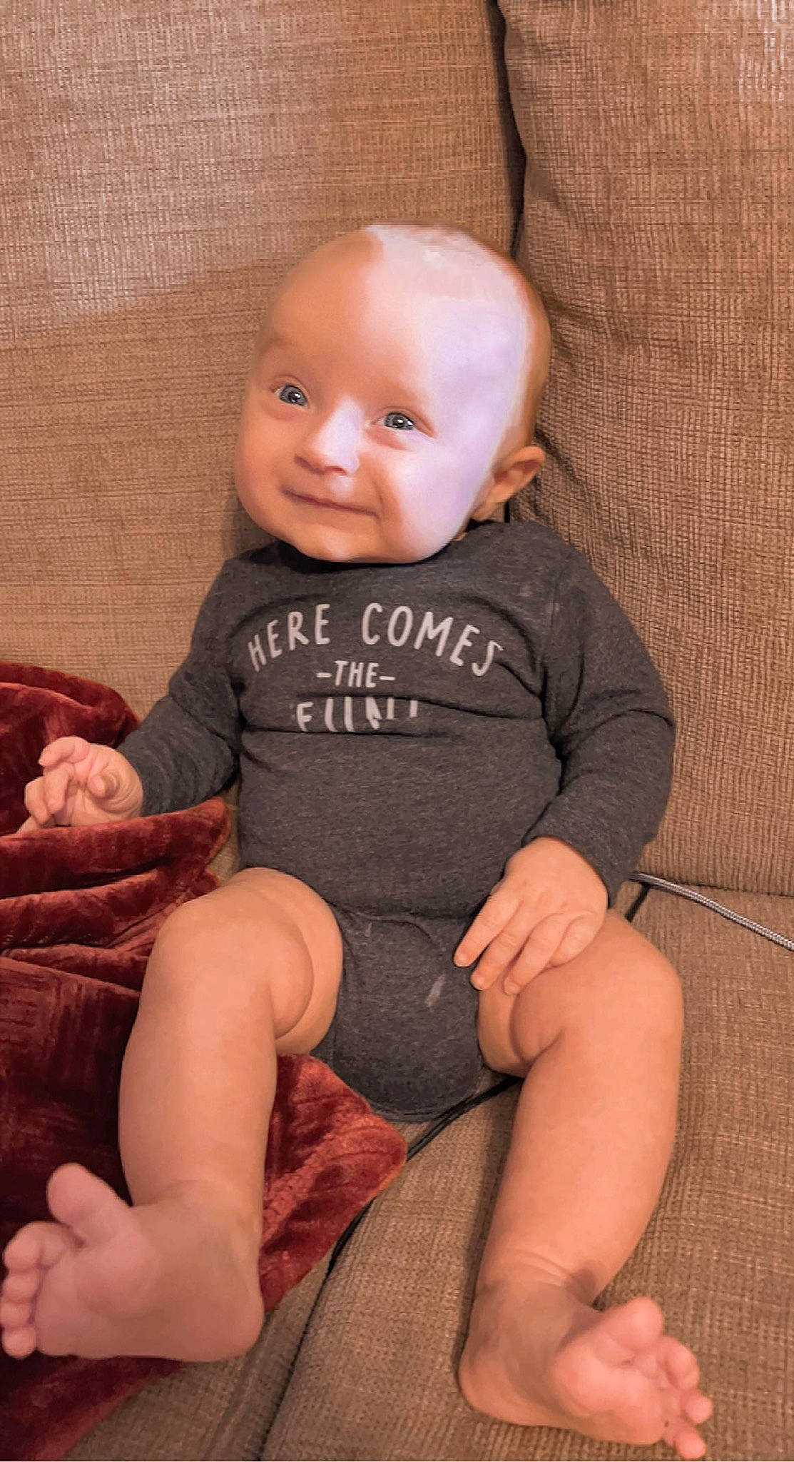 Dallas is registered to the contest to win money with this photo: baby_toddler_clothing, cheek, chin, comfort, eye, face, finger, head, human_body, joint, leg, mouth, neck, nose, person, product, skin, sleeve, smile, textile
