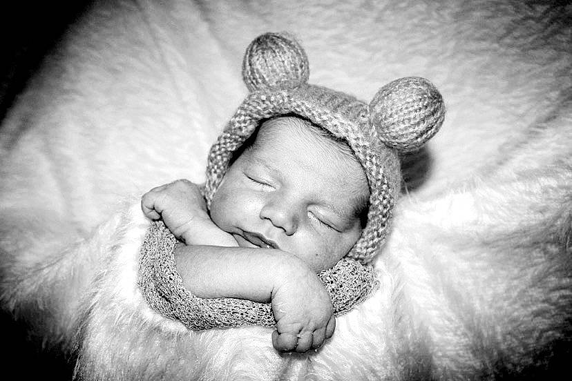 Deklan is registered to the contest to win money with this photo: arm, baby, baby_sleeping, cap, close_up, comfort, ear, eye, face, flash_photography, gesture, grass, happy, head, headgear, headpiece, linens, monochrome, monochrome_photography, person
