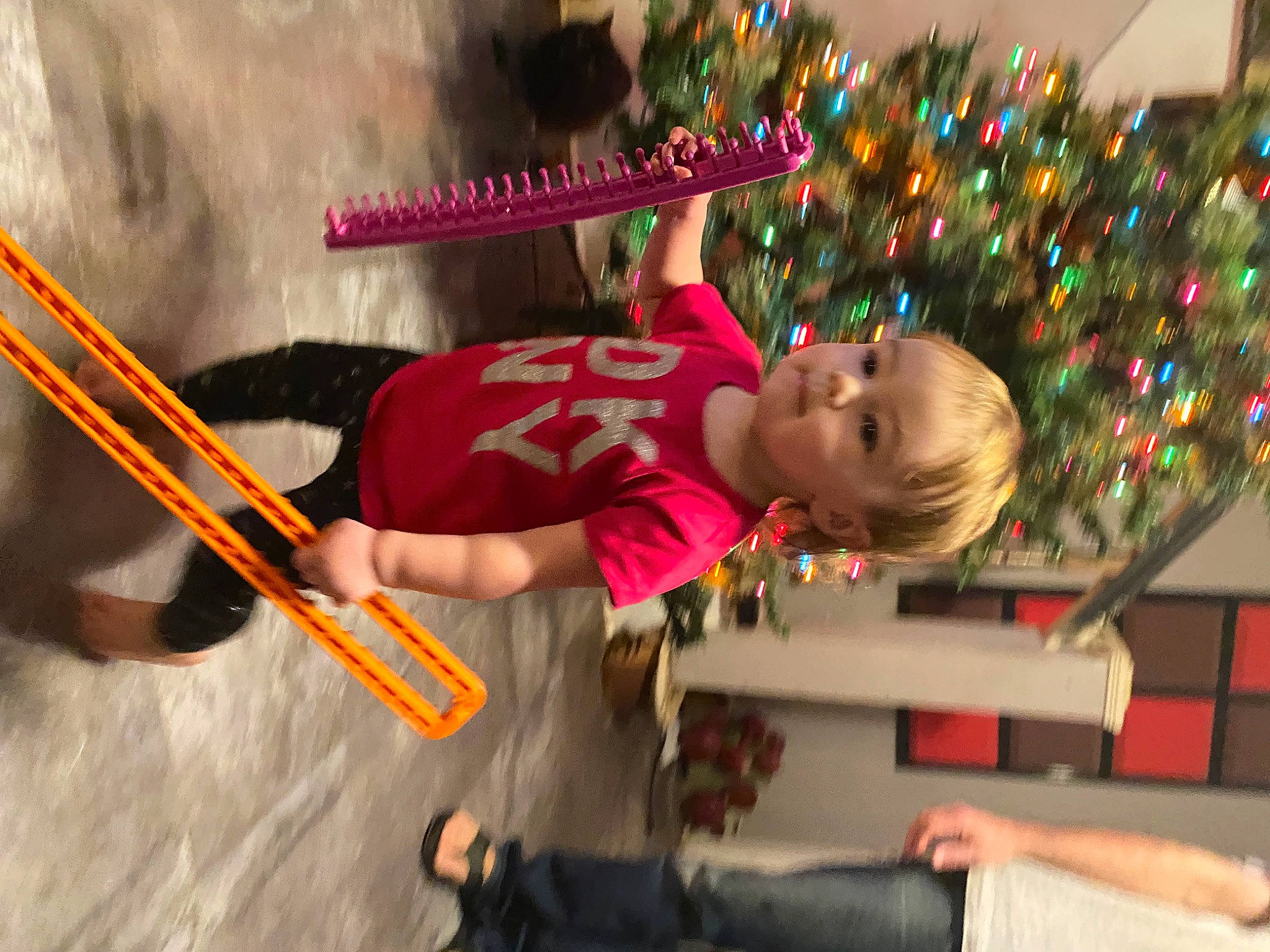 Katelyn is registered to the contest to win money with this photo: child, christmas, christmas_decoration, christmas_ornament, christmas_tree, drum_stick, event, fun, happy, hat, holiday, person, plant, toddler, tradition, tree