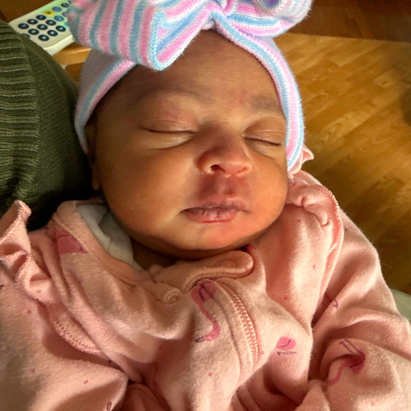 Eliana joined the competition — help win amazing prizes! baby, infant, sleeping, pink_clothing, headwear, bow, striped, pastel_colors, close_up, indoor, wooden_floor, peaceful, cozy, child, newborn, portrait, soft_lighting, cute, warm, relaxed