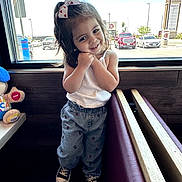Jasmine Miamor joined the competition — help win amazing prizes! bench_seating, bow, cars, casual_clothing, child, cute, daylight, girl, hair_accessory, indoor, jeans, parking_lot, plush_toy, pose, restaurant, smile, sneakers, white_tank_top, window, wood_paneling