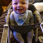 Odin joined the competition — help win amazing prizes! baby, smiling, infant, child, baby_seat, bib, pajamas, happy, cute, indoor, face, person, seat, clothing, legs, hands, head, expression, comfort, portrait