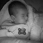 Inaya participe au concours pour gagner de l'argent avec cette photo : baby, sleeping, blanket, soft, cozy, infant, face, peaceful, wrapped, bed, monochrome, portrait, child, cute, rest, indoors, young, calm, pajamas, closeup