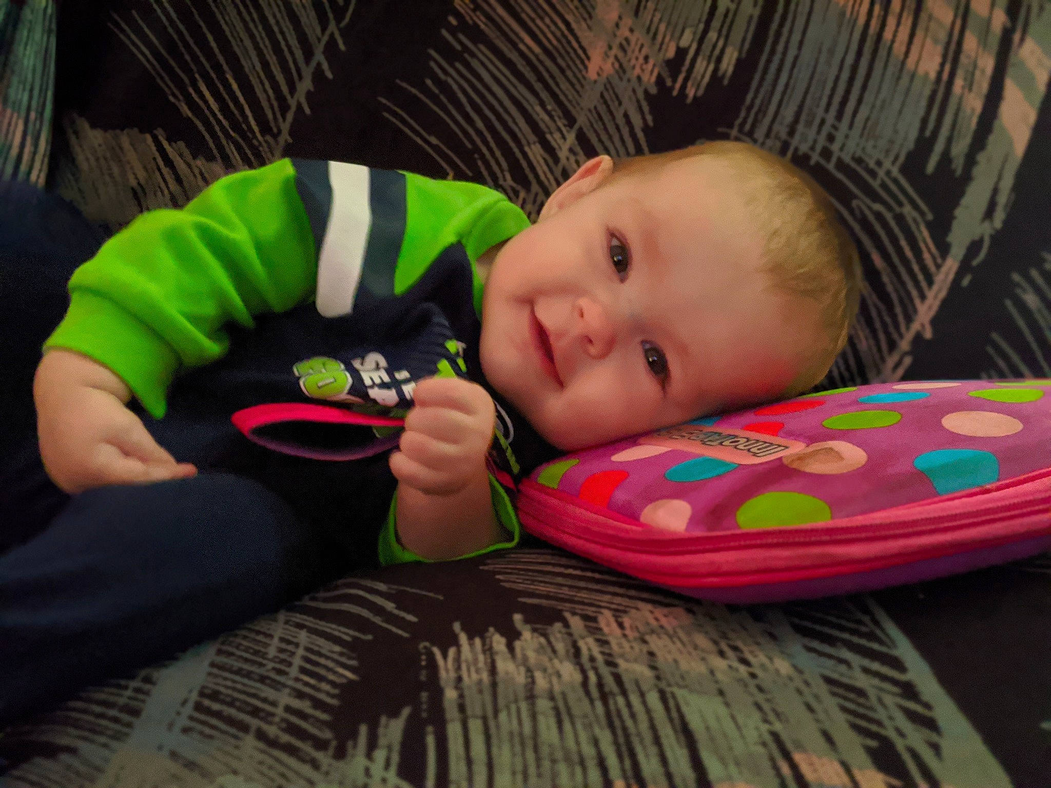 Astrid is registered to the contest to win money with this photo: baby, baby_toddler_clothing, cheek, child, clothing, comfort, eye, flooring, fun, grass, happy, human_body, iris, mammal, person, skin, sleeve, smile, textile, toddler