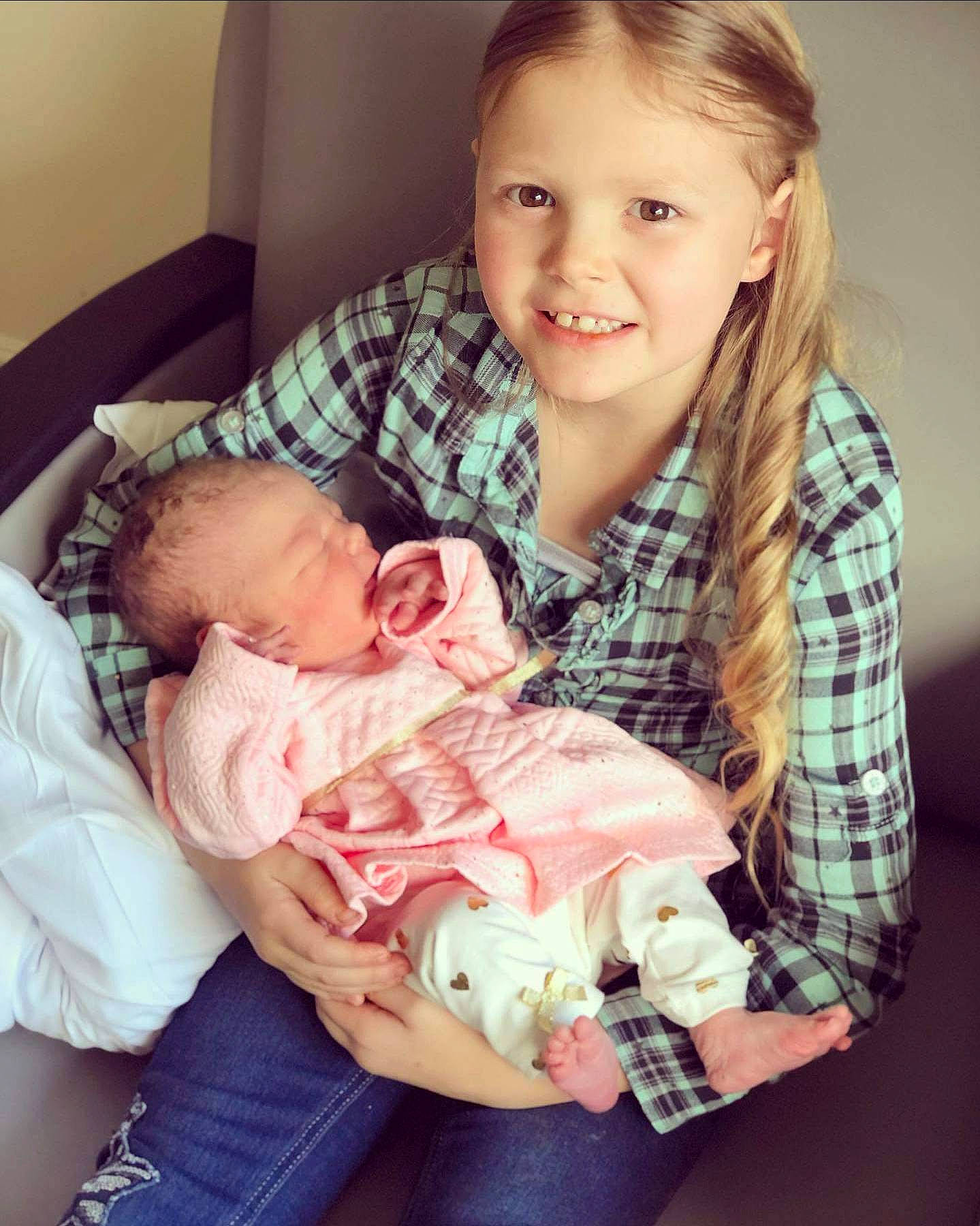 Harlie is registered to the contest to win money with this photo: arm, baby_toddler_clothing, cheek, comfort, eye, face, facial_expression, finger, gesture, hair, hairstyle, hand, happy, head, jeans, joy, lap, mouth, person, skin