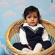 Gurniwaz joined the competition — help win amazing prizes! toddler, child, wicker_chair, blue_background, clouds, indoor, portrait, serious_expression, clothing, navy_sweater, white_shirt, footwear, baby, cute, sitting, furniture, person, studio, photography, young_child