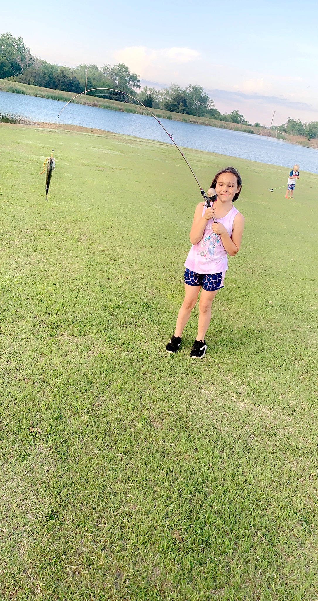 Laihla is registered to the contest to win money with this photo: angling, fisherman, fishing_rod, fun, grass, grassland, happy, horizon, joy, landscape, leisure, meadow, outdoor_recreation, people_in_nature, person, plain, recreation, recreational_fishing, shorts, sky