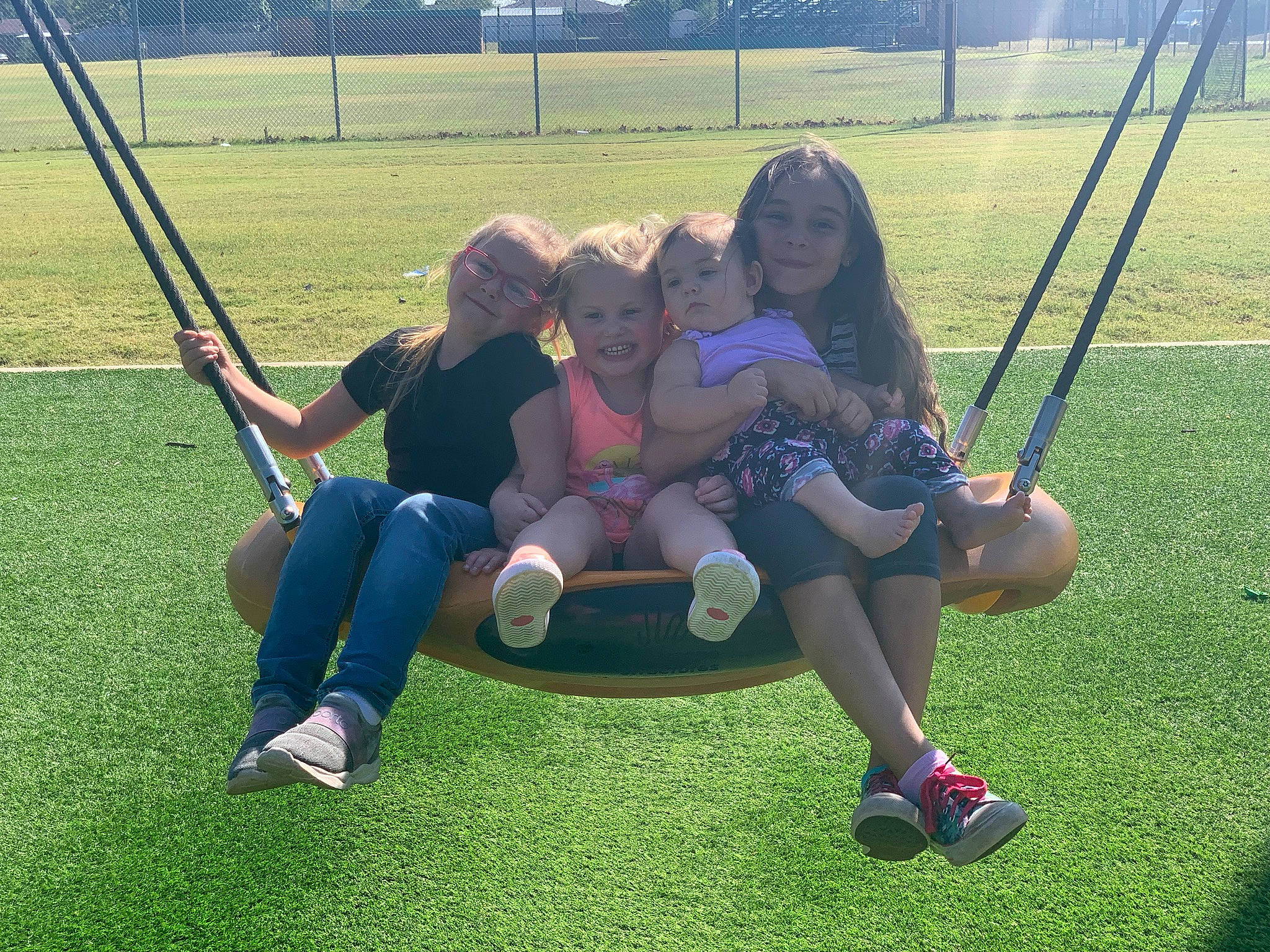 Calliope Rhayne joined the competition — help win amazing prizes! footwear, fun, grass, happy, joy, knee, leg, leisure, outdoor_play_equipment, outdoor_recreation, person, plant, playground, recreation, shoe, shorts, smile, sneakers, swing, tire