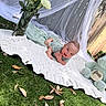 Matteo joined the competition — help win amazing prizes! baby, infant, child, smiling, waving, tummy_time, portrait, outdoor, garden, flowers, white_roses, blanket, plush_toy, elephant, grass, leaves, wooden_fence, decorative_netting, star_pattern, pastel_colors