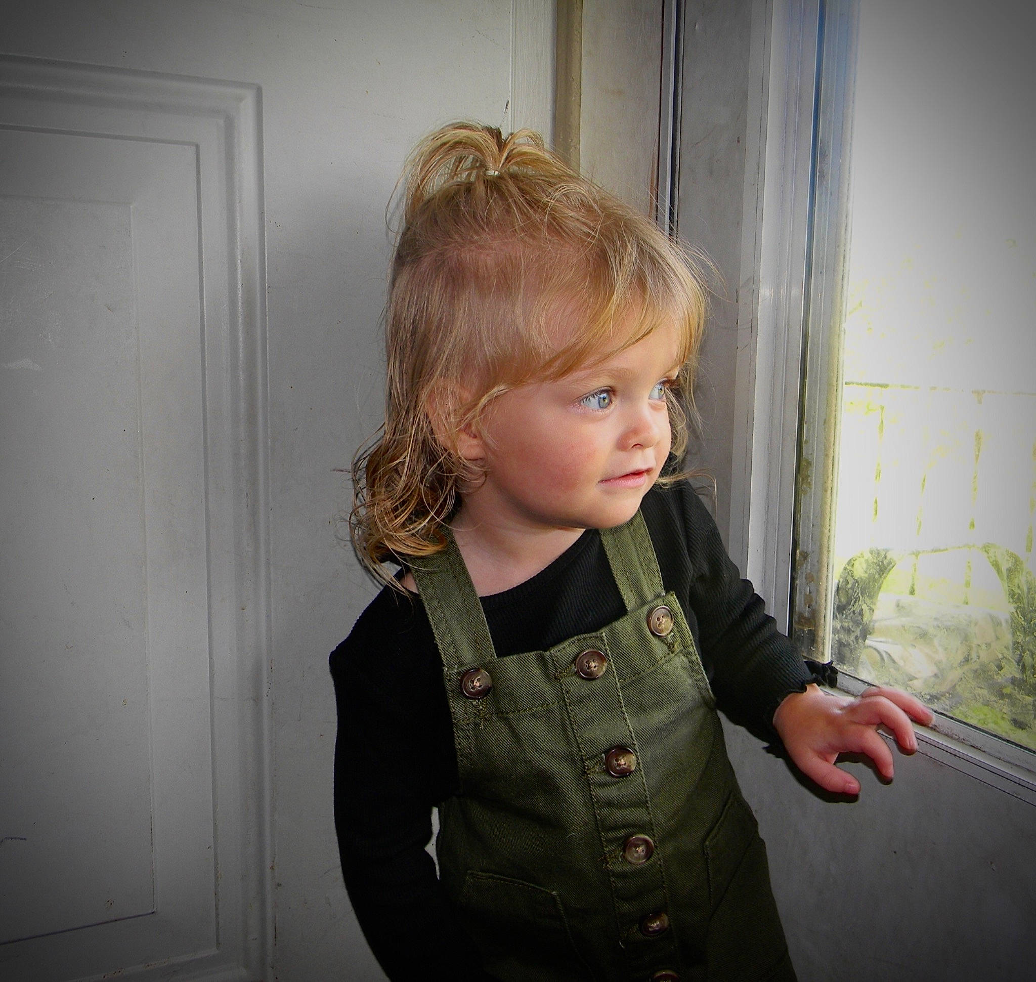 Harper is registered to the contest to win money with this photo: bangs, blond, brown_hair, button, cheek, child, door, fashion_design, flash_photography, iris, long_hair, outerwear, pattern, person, plant, sleeve, tints_and_shades, toddler, waist, window