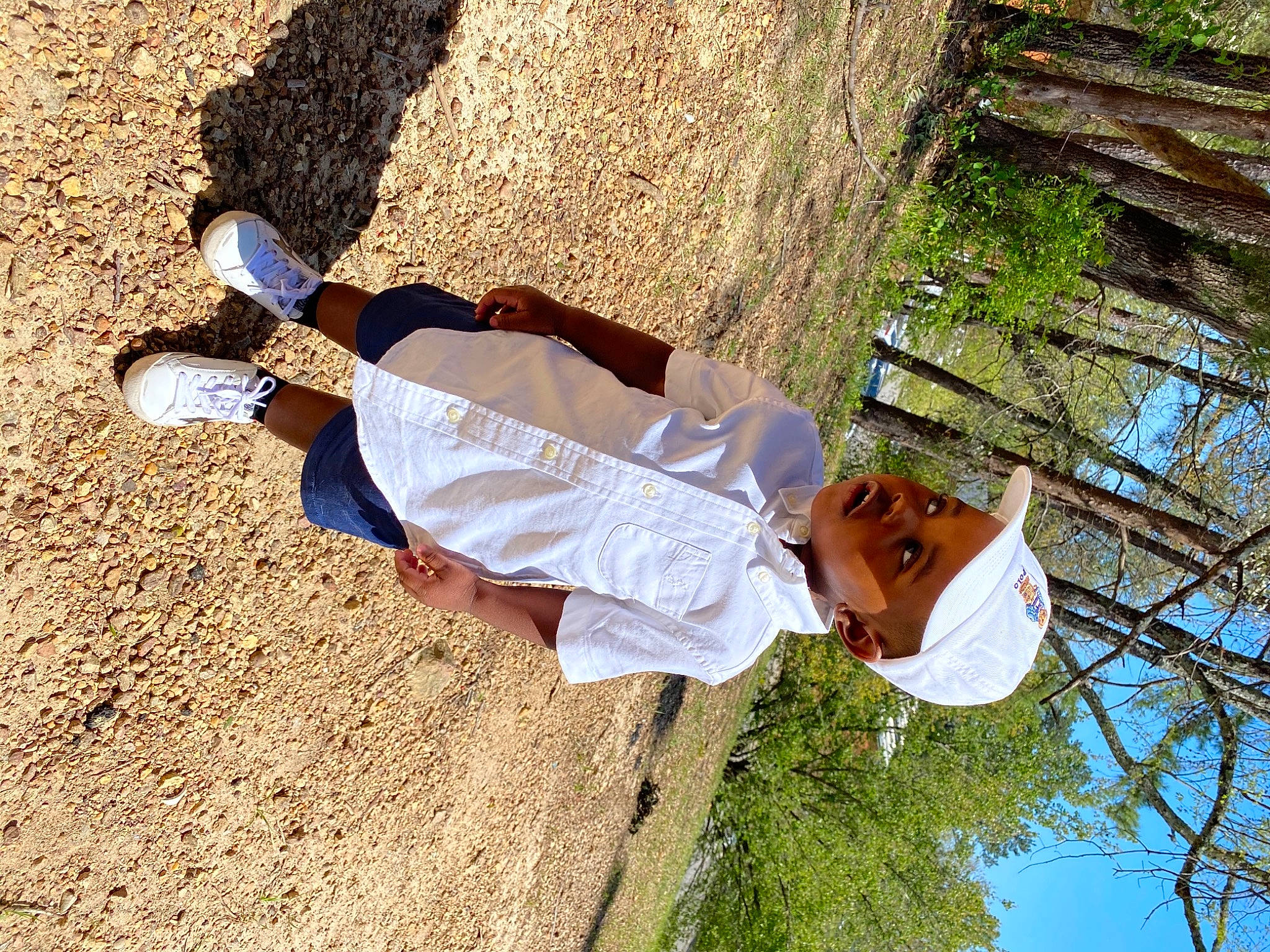 Ace is registered to the contest to win money with this photo: foot, fun, grass, happy, hat, human_leg, landscape, leisure, people_in_nature, person, plant, recreation, shadow, sitting, sneakers, soil, tree, walking_shoe