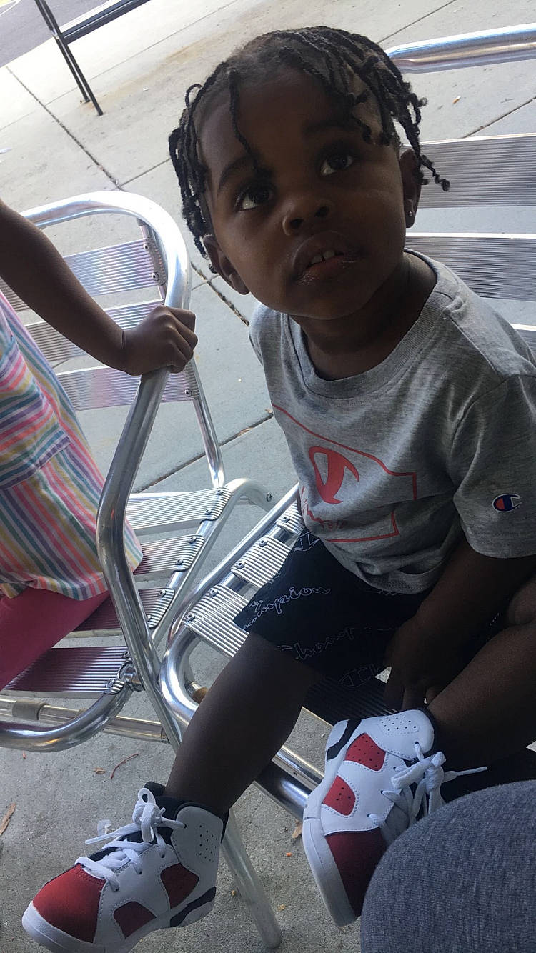 Ace is registered to the contest to win money with this photo: audio_equipment, automotive_tire, black, child, cool, face, fun, hairstyle, human_leg, knee, person, recreation, sitting, sneakers, sock, sports_gear, sportswear, t_shirt, technology, thigh