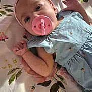 Maelyn is registered to the contest to win money with this photo: baby, infant, child, portrait, lying_down, pacifier, headband, bunny_ears, floral_blanket, blue_dress, smiling, awake, face, hand, indoor, bed, soft_lighting, adorable, baby_clothing, photography