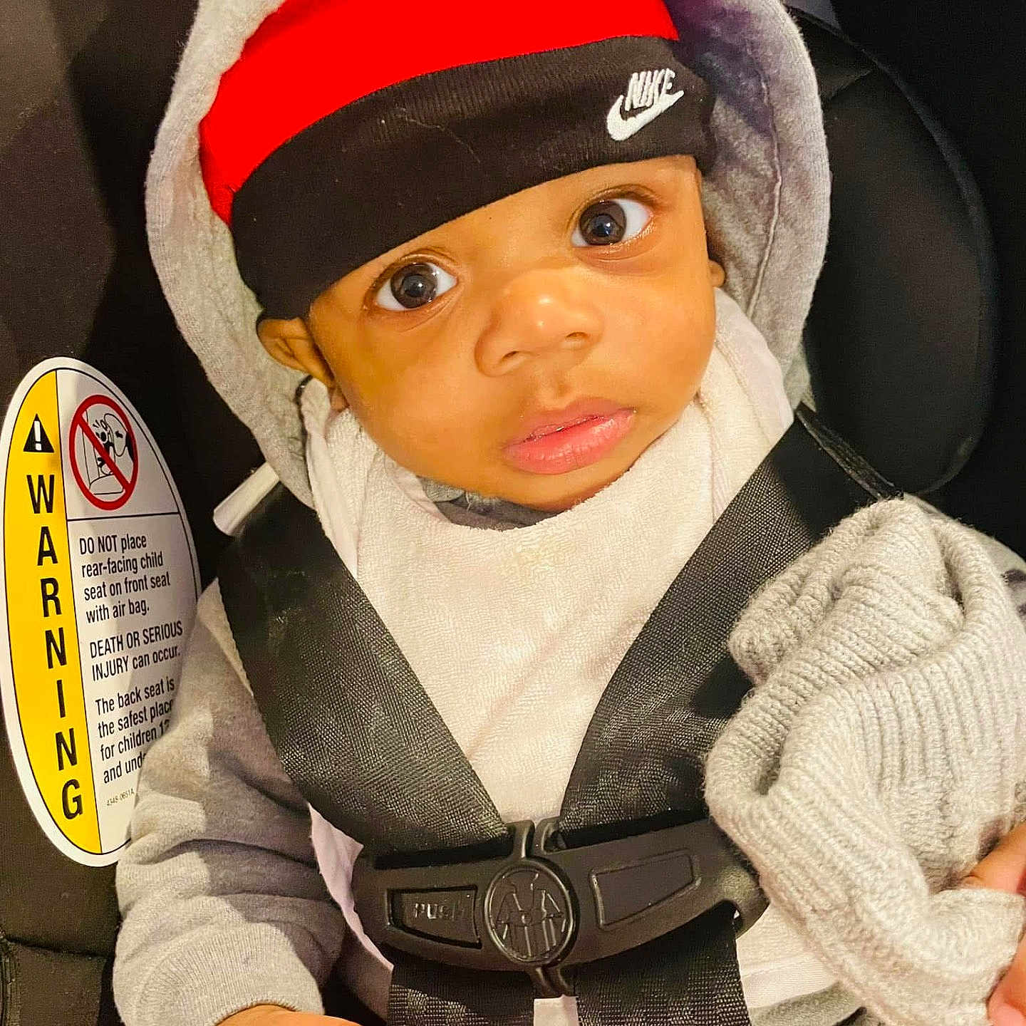 Lennox joined the competition — help win amazing prizes! baby, car_seat, child, closeup, clothing, cute, expression, hand, hat, headband, hoodie, indoors, infant, knit_cap, nike, person, portrait, safety, seat_belt, warning_label
