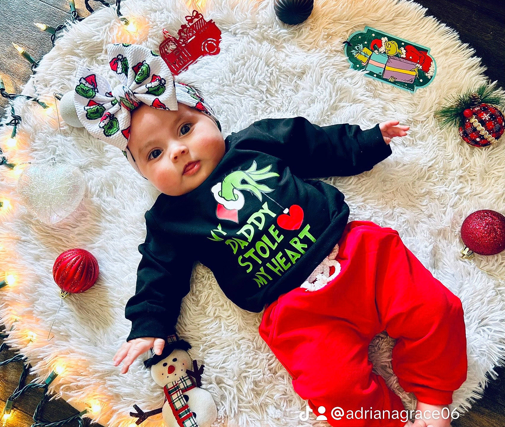 Scarlett is registered to the contest to win money with this photo: baby, baby_toddler_clothing, carmine, child, christmas, christmas_eve, costume_hat, event, fictional_character, fun, fur, happy, headgear, headwear, holiday, outerwear, pattern, person, product, sleeve