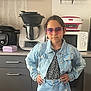 Sarah a rejoint le concours — aidez-le/la à gagner de superbes lots ! child, girl, denim_jacket, denim_skirt, sunglasses, kitchen, appliances, microwave, modern, confident, standing, fashion, casual, hands_on_hips, white_tights, black_flower_top, home_interior, cabinet, countertop, young_girl