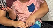 Zeeland joined the competition — help win amazing prizes! carpet, casual_clothing, child, family, glasses, happy, holding, indoor, interaction, people, person, portrait, seated, shirt, shorts, smile, socks, toddler, wall, young