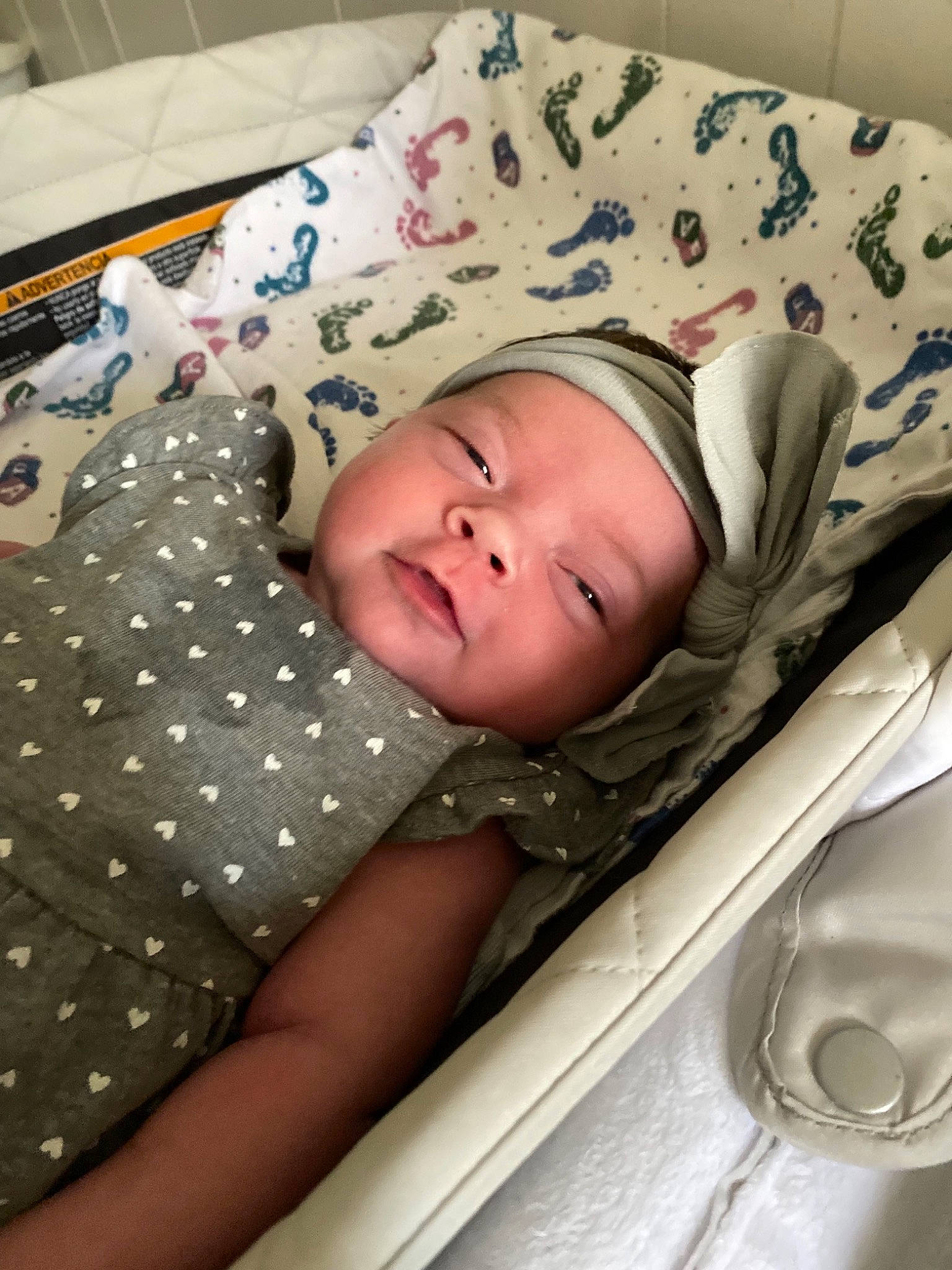 Emma is registered to the contest to win money with this photo: baby, baby_products, baby_safety, baby_toddler_clothing, bed, bedding, bedtime, cheek, child, comfort, eye, face, head, headwear, infant_bed, linens, pattern, person, room, sleeve