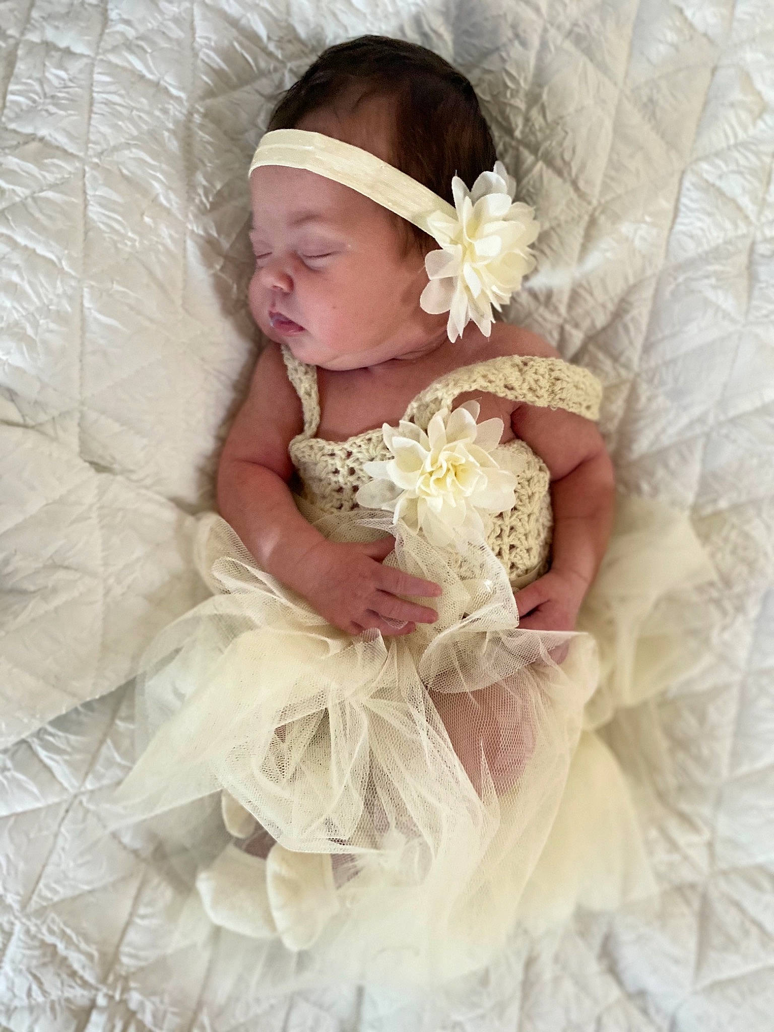 Emma is registered to the contest to win money with this photo: baby, baby_toddler_clothing, bridal_accessory, dress, embellishment, flash_photography, flower, hand, happy, headband, headgear, headpiece, headwear, iris, jewellery, person, petal, pink, plant, ruffle