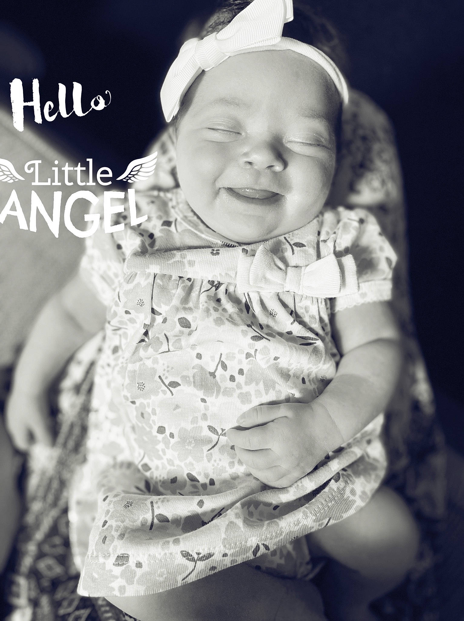 Emma is registered to the contest to win money with this photo: baby, baby_toddler_clothing, black_and_white, cap, eye, facial_expression, flash_photography, gesture, hairstyle, happy, human, iris, mammal, organ, person, photograph, skin, sleeve, smile, standing