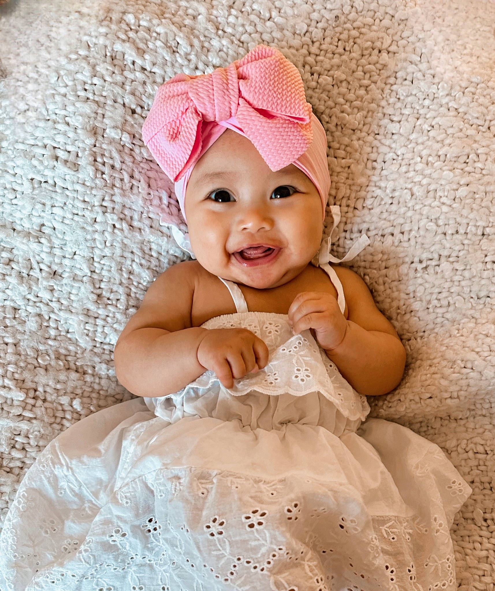 Emma is registered to the contest to win money with this photo: baby, baby_toddler_clothing, bridal_accessory, child, dress, embellishment, event, face, fashion_accessory, flash_photography, happy, headpiece, headwear, magenta, pattern, peach, person, pink, sleeve, smile