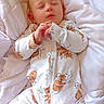 baby, sleeping, onesie, koala_print, white_bedding, infant, peaceful, cute, child, soft_texture, bed, hands, face, closed_eyes, cozy, rest, portrait, indoor, comfort, young