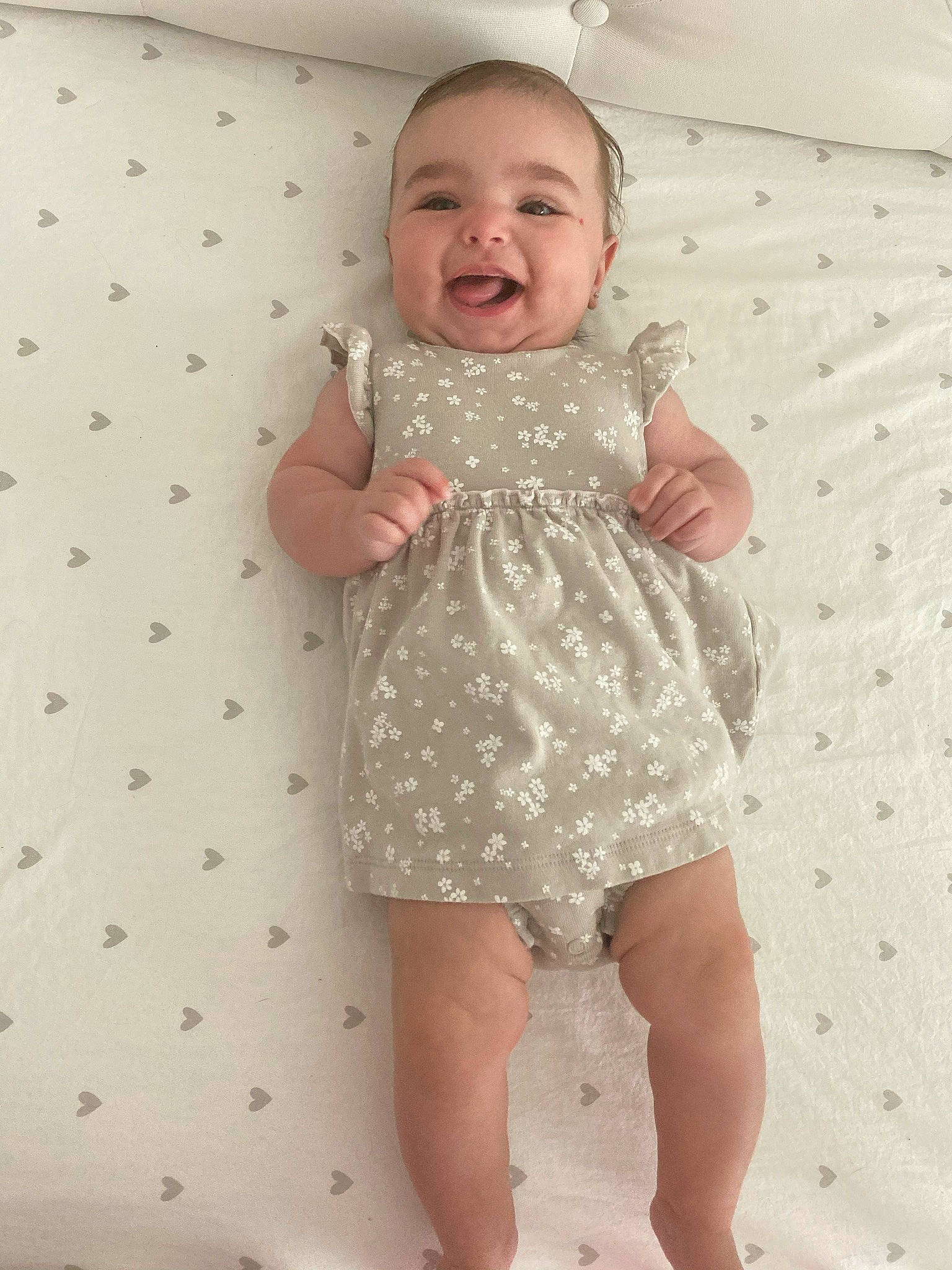 Meadow is registered to the contest to win money with this photo: arm, baby_toddler_clothing, cheek, day_dress, dress, eye, face, finger, happy, head, joint, leg, one_piece_garment, person, pink, skin, sleeve, smile, standing, textile