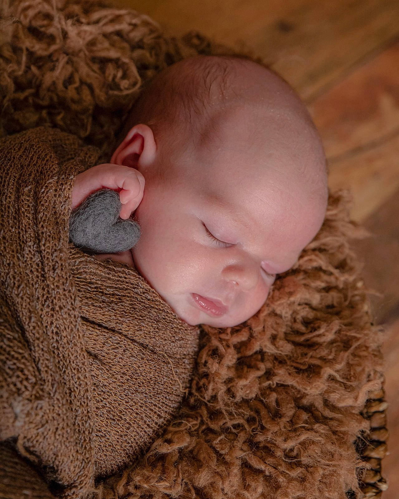 Brett is registered to the contest to win money with this photo: baby, baby_toddler_clothing, brown, cheek, comfort, craft, creative_arts, fawn, hay, knitting, natural_material, peach, person, skin, sleep, sweater, textile, thread, wool, woolen
