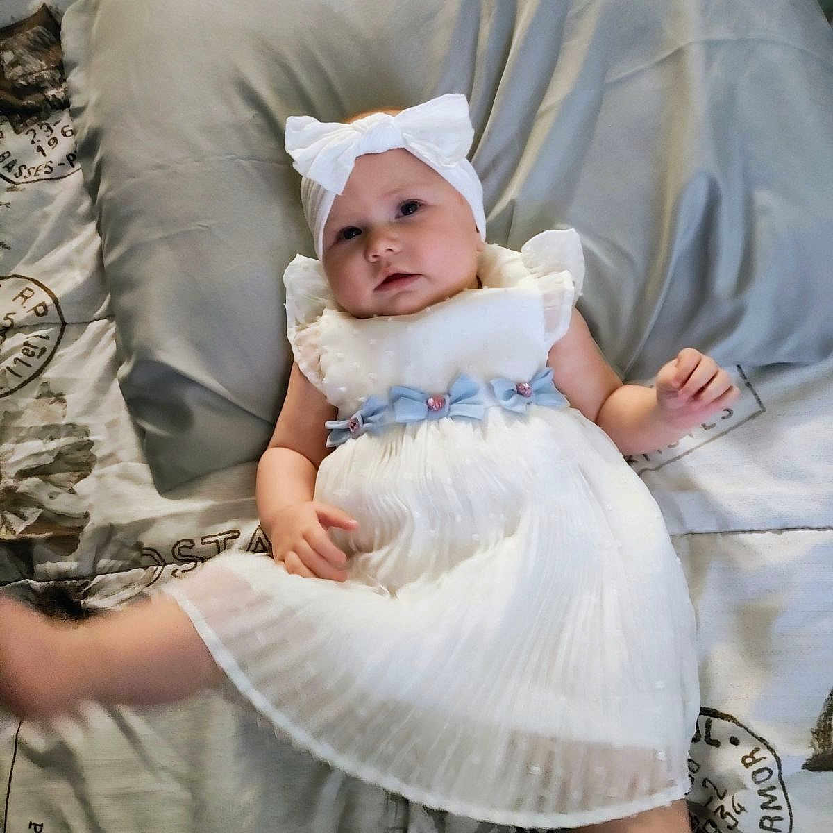 Vayda is registered to the contest to win money with this photo: baby, bed, bedroom, bonnet, clothing, couch, cushion, dress, face, furniture, hat, head, homedecor, indoors, newborn, person, photography, pillow, portrait, room