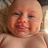 Blake is registered to the contest to win money with this photo: baby, bare_chest, blanket, cheeks, child, closeup, cute, dimples, expression, face, happy, head, infant, lying_down, newborn, portrait, skin, smile, soft_light, tongue