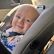Blake joined the competition — help win amazing prizes! baby, blue_eyes, car_interior, car_seat, child, closeup, cute, daylight, face, happy, infant, infant_clothing, portrait, safety_harness, seat, seatbelt, smile, sunlight, window, young_child