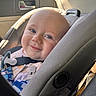 baby, blue_eyes, car_interior, car_seat, child, closeup, cute, daylight, face, happy, infant, infant_clothing, portrait, safety_harness, seat, seatbelt, smile, sunlight, window, young_child