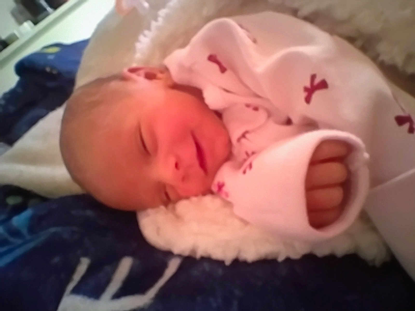 Jordyn is registered to the contest to win money with this photo: newborn, baby, sleeping, blanket, pink_clothing, hand, cozy, soft_texture, infant, peaceful, closeup, indoors, cute, wrapped, resting, toddler, child, face, clothing, warm