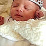 Jordyn is registered to the contest to win money with this photo: newborn, baby, sleeping, tiara, crown, blanket, soft, cute, infant, cozy, face, hand, headwear, rest, closeup, portrait, child, peaceful, indoors, warm