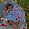 baby, baby_bottle, blanket, bottle, chair, child, clothing, crochet_blanket, cute, face, foot, grass, hand, infant, outdoor, person, rainbow_pattern, relaxing, sitting, time_overlay