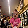 Araceli joined the competition — help win amazing prizes! toddler, child, pink_shirt, shoe, hair_tie, grocery_store, aisle, cooler, shopping, clothing, person, indoor, floor, table, sitting, holding, casual, retail, young_child, cute